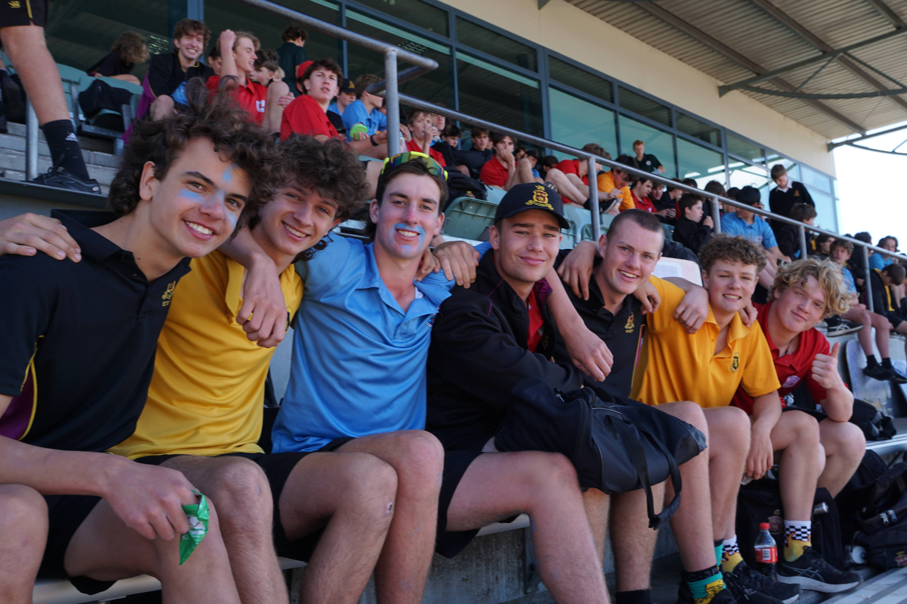 Students in house colours at a sporting event.